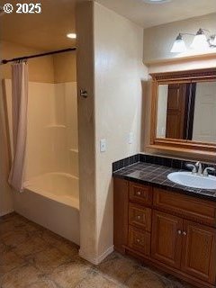 bathroom featuring shower / bathtub combination with curtain and vanity