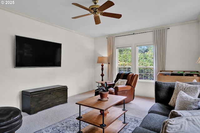 living area featuring carpet flooring, crown molding, ceiling fan, and baseboards