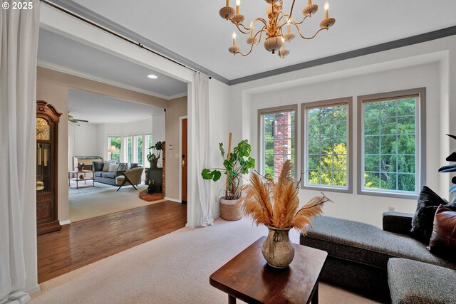 living area with carpet floors, ornamental molding, a chandelier, baseboards, and recessed lighting