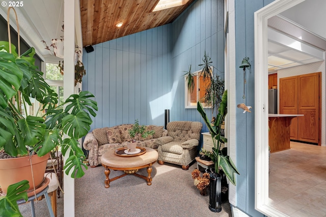 living room with lofted ceiling, wooden walls, and wood ceiling