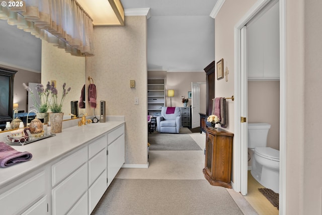 full bath with ornamental molding, vanity, toilet, and baseboards