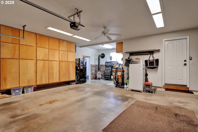 garage featuring a garage door opener and freestanding refrigerator