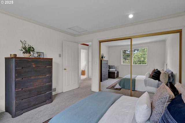 carpeted bedroom with attic access, a closet, ornamental molding, and recessed lighting