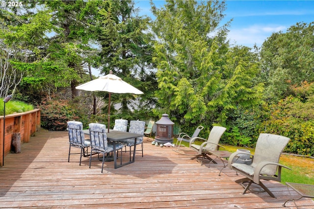 wooden deck featuring outdoor dining area