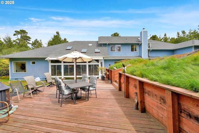 wooden deck featuring outdoor dining space