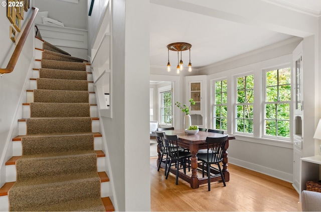 dining room featuring crown molding and light wood-type flooring