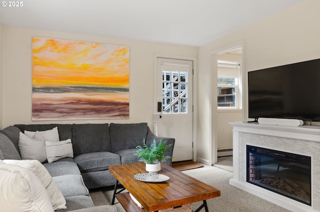 living room featuring a baseboard heating unit and light carpet