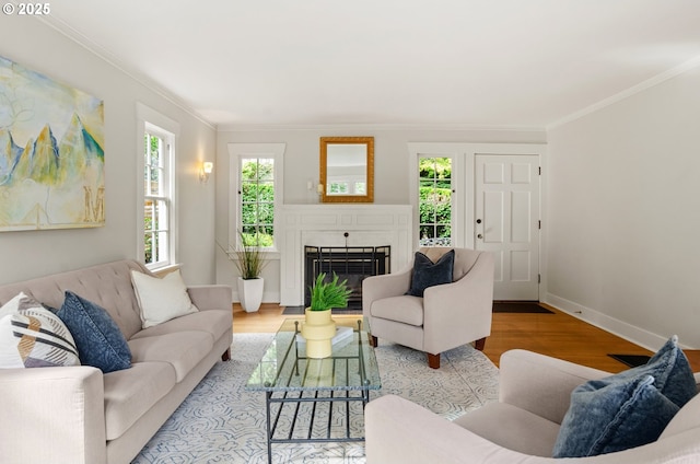 living room featuring a brick fireplace, light hardwood / wood-style flooring, and ornamental molding