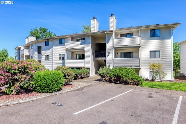 11044 SW Greenburg Rd Unit 321, Portland, OR 97223 - view of property featuring uncovered parking