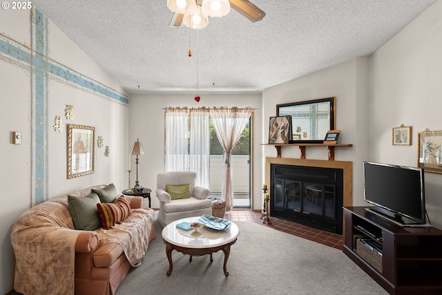 11044 SW Greenburg Rd Unit 321, Portland, OR 97223 - living room with a fireplace with flush hearth, a ceiling fan, tile patterned floors, a textured ceiling, and carpet flooring