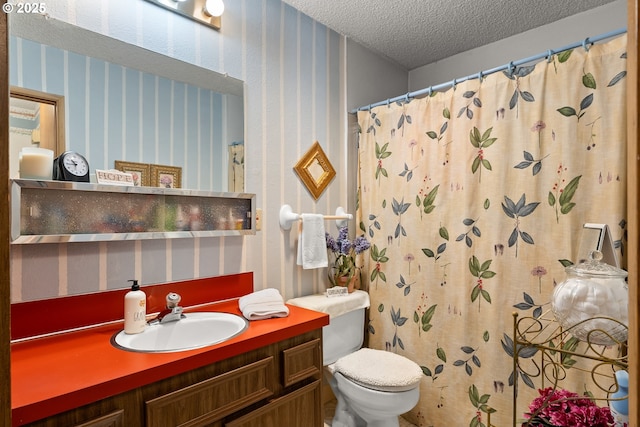 11044 SW Greenburg Rd Unit 321, Portland, OR 97223 - full bathroom with wallpapered walls, a textured ceiling, toilet, vanity, and a shower with curtain