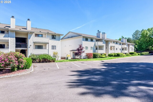 11044 SW Greenburg Rd Unit 321, Portland, OR 97223 - view of building exterior with uncovered parking