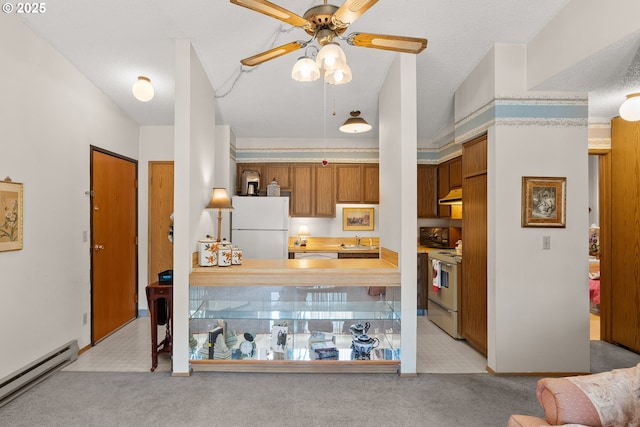 11044 SW Greenburg Rd Unit 321, Portland, OR 97223 - kitchen featuring white appliances, a baseboard radiator, a sink, and light colored carpet