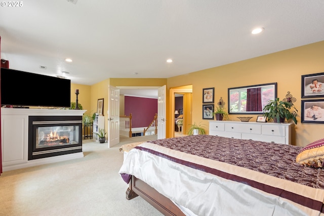 bedroom featuring recessed lighting, carpet floors, and a multi sided fireplace