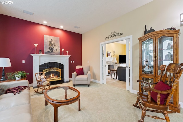 living area with a fireplace, recessed lighting, light carpet, and baseboards