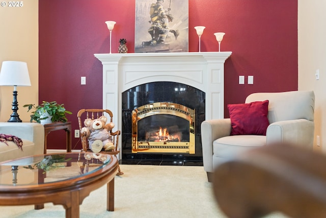 living area featuring a fireplace with flush hearth and carpet floors