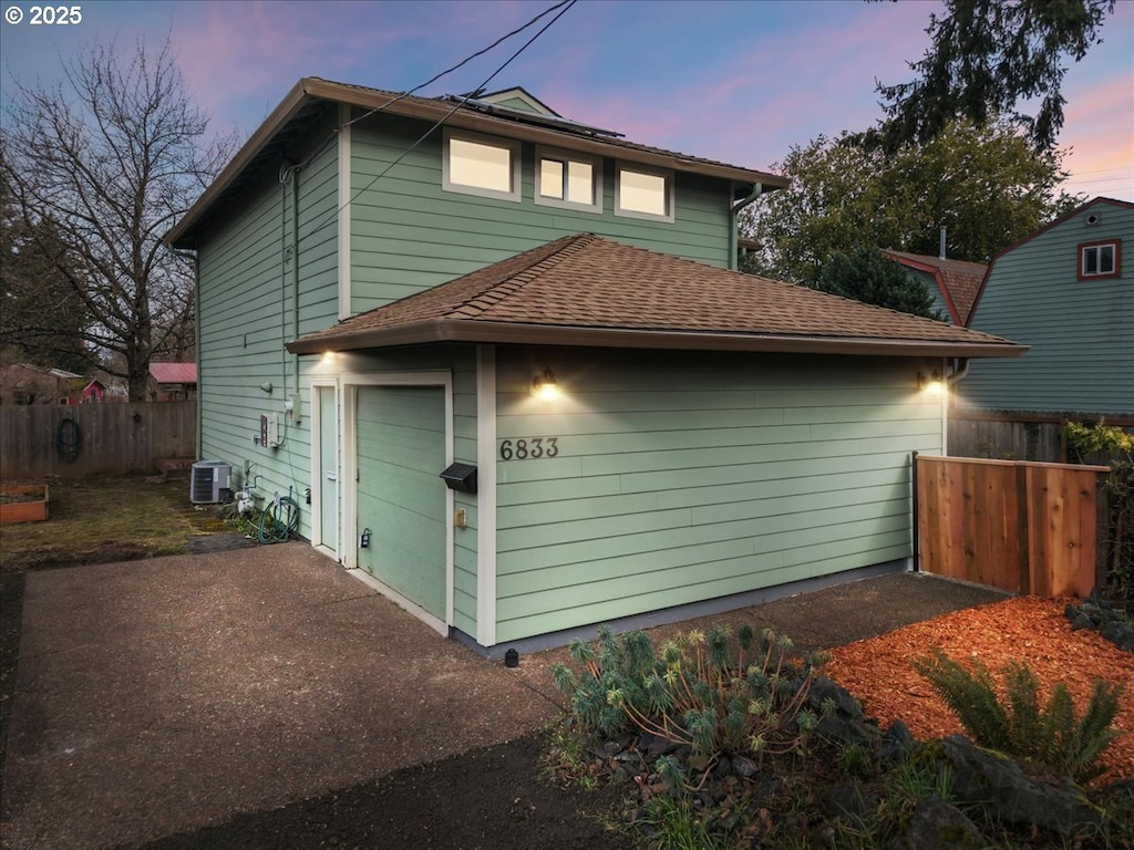 property exterior at dusk featuring central AC