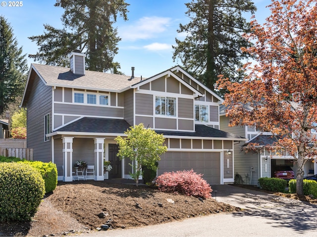 view of front of home with covered porch, a chimney, a shingled roof, concrete driveway, and an attached garage