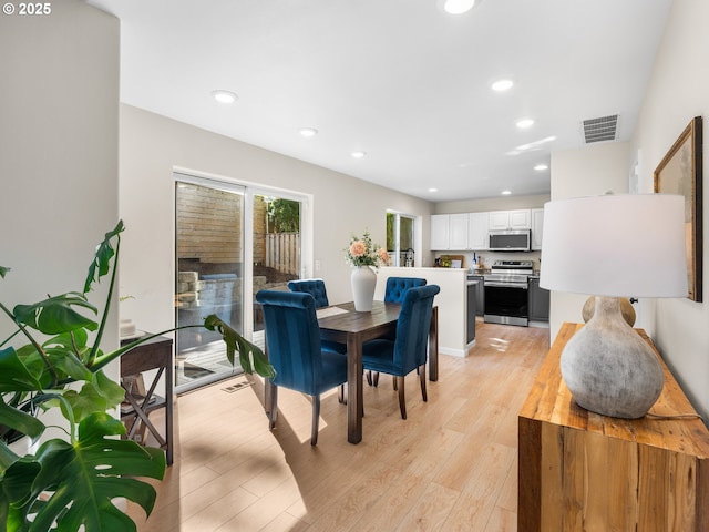 dining space featuring recessed lighting, visible vents, and light wood-style floors