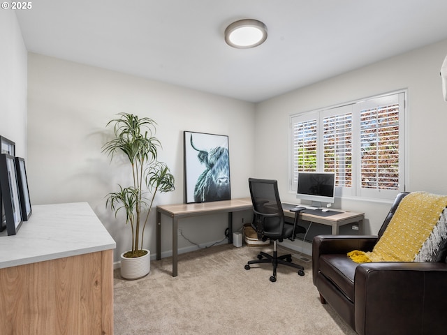 home office with baseboards and light carpet