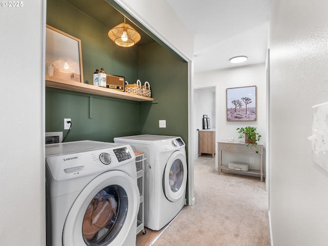 laundry room featuring light colored carpet and washer and dryer