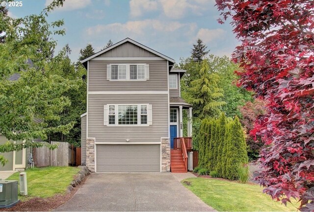 view of front of home with a front yard and a garage