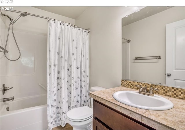 full bathroom featuring decorative backsplash, toilet, vanity, and shower / tub combo