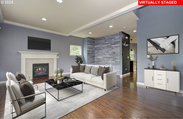 living room featuring dark wood-type flooring and a tiled fireplace