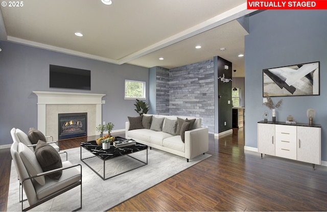 living room with dark hardwood / wood-style floors and a tile fireplace