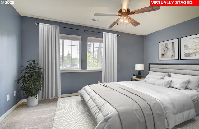 bedroom with ceiling fan and light carpet