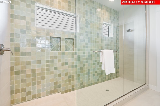 bathroom with a tile shower