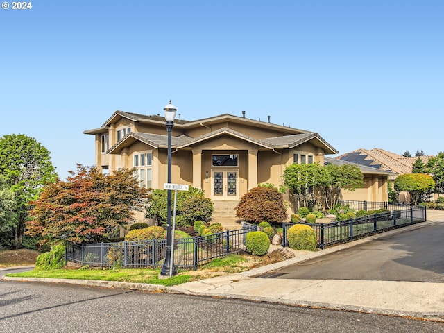 9112 NW Wiley Ln, Portland, OR 97229 - view of front of house featuring stucco siding and a fenced front yard