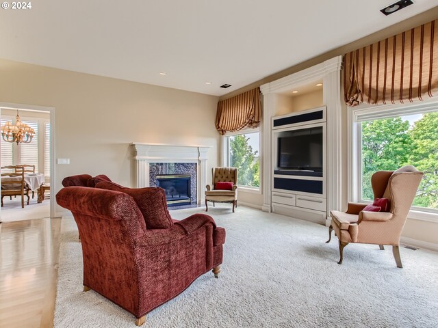 9112 NW Wiley Ln, Portland, OR 97229 - living room with plenty of natural light, a chandelier, a premium fireplace, and light colored carpet