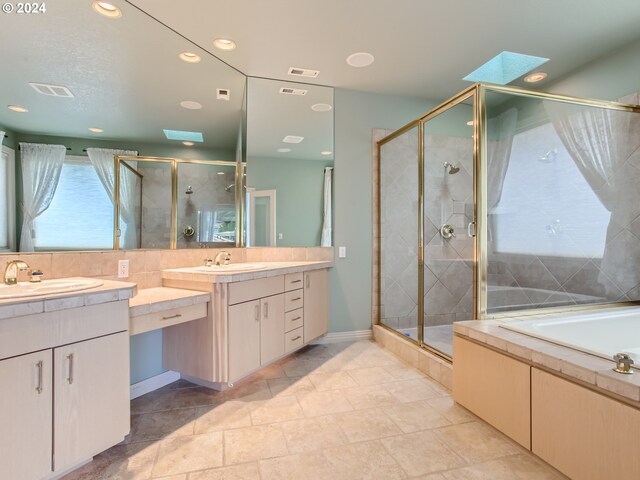 9112 NW Wiley Ln, Portland, OR 97229 - full bath featuring a stall shower, two vanities, recessed lighting, a skylight, and baseboards