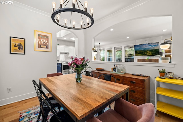 9628 N Exeter Ave, Portland, OR 97203 - dining room with a chandelier, arched walkways, recessed lighting, wood finished floors, and crown molding