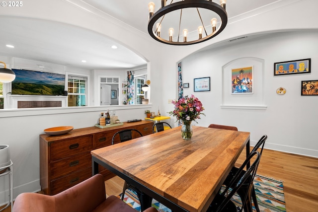 9628 N Exeter Ave, Portland, OR 97203 - dining room featuring wood finished floors, a chandelier, recessed lighting, and arched walkways