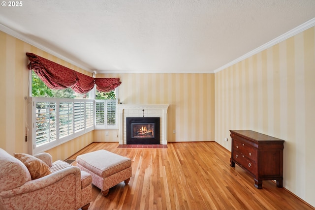 316 E 27th St, Vancouver, WA 98663 - living room featuring wallpapered walls, wood finished floors, crown molding, and a fireplace