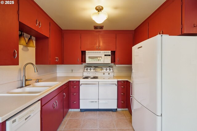 316 E 27th St, Vancouver, WA 98663 - kitchen with white appliances, red cabinetry, light tile patterned flooring, and light countertops