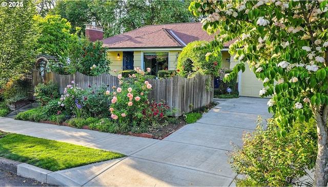 316 E 27th St, Vancouver, WA 98663 - view of front of house with a garage, concrete driveway, a chimney, and a shingled roof