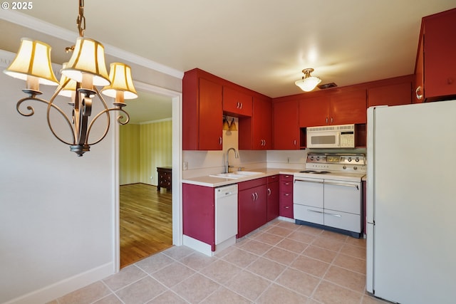 316 E 27th St, Vancouver, WA 98663 - kitchen with white appliances, a chandelier, red cabinetry, light countertops, and crown molding