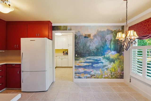316 E 27th St, Vancouver, WA 98663 - kitchen with freestanding refrigerator, a chandelier, light tile patterned floors, light countertops, and wallpapered walls
