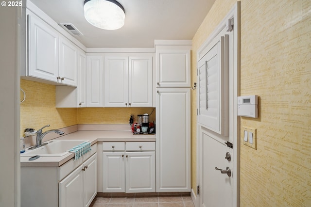 316 E 27th St, Vancouver, WA 98663 - kitchen featuring white cabinets, light countertops, backsplash, and light tile patterned floors