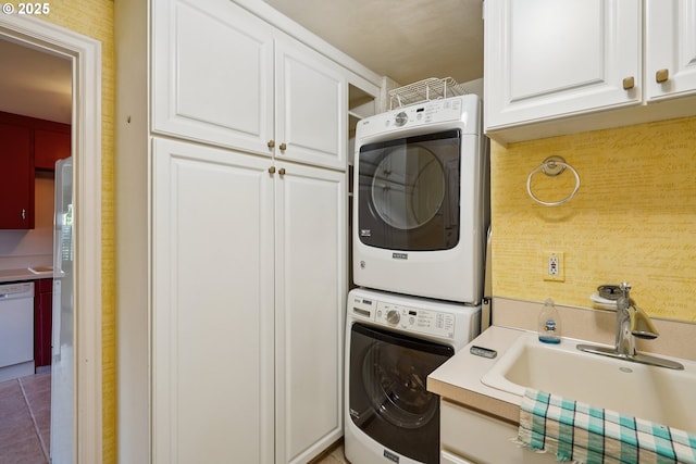 316 E 27th St, Vancouver, WA 98663 - washroom featuring estacked washer and dryer, cabinet space, and tile patterned floors