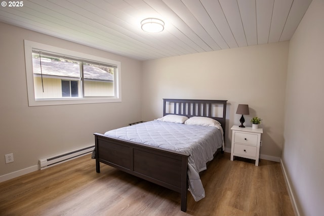 29311 Joy Ln, Ocean Park, WA 98640 - bedroom with a baseboard radiator, wood finished floors, baseboards, and wooden ceiling