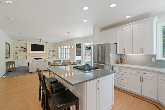 10440 SW 141st Ave, Beaverton, OR 97008 - kitchen with appliances with stainless steel finishes, ceiling fan, white cabinetry, light wood-type flooring, and recessed lighting