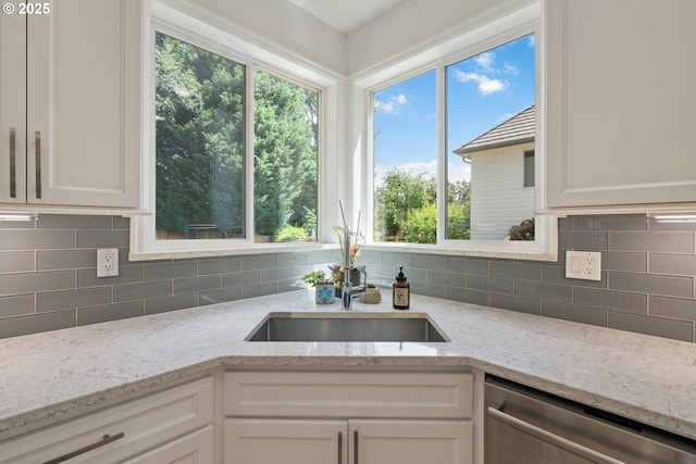10440 SW 141st Ave, Beaverton, OR 97008 - kitchen with dishwasher, white cabinetry, backsplash, and light stone countertops