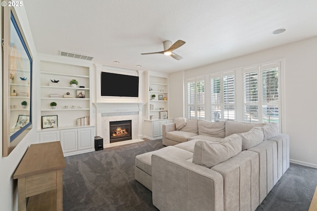 10440 SW 141st Ave, Beaverton, OR 97008 - living area with ceiling fan, dark colored carpet, and a high end fireplace