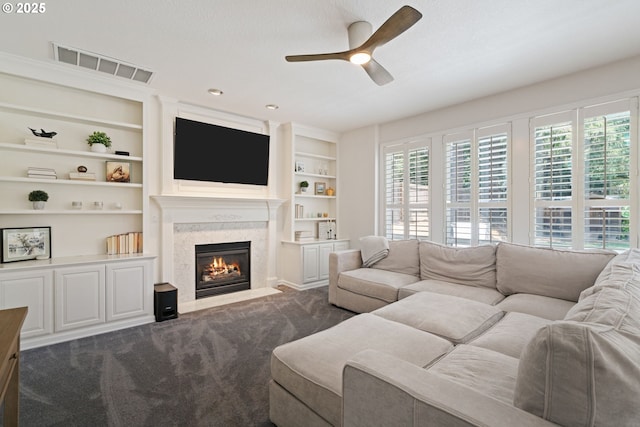10440 SW 141st Ave, Beaverton, OR 97008 - living room with ceiling fan, plenty of natural light, a premium fireplace, and dark carpet
