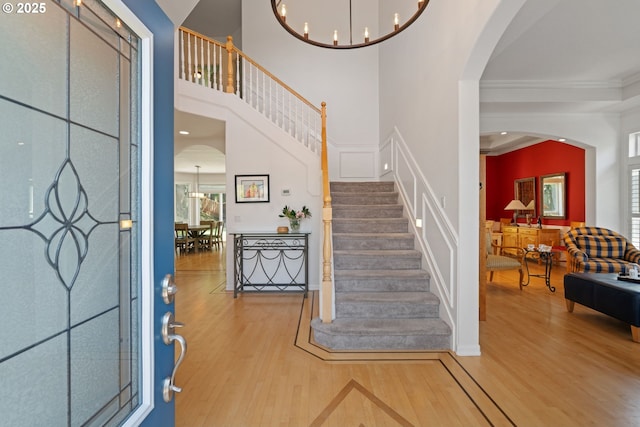 10440 SW 141st Ave, Beaverton, OR 97008 - foyer entrance with wood finished floors, ornamental molding, stairway, arched walkways, and a decorative wall