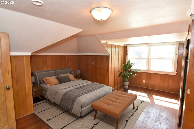 210 Holeman Ave, Eugene, OR 97404 - bedroom featuring hardwood / wood-style flooring, wooden walls, and lofted ceiling